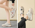  Women Breathable Casual Sneakers worn with a black hoodie, showcasing light comfort shoes in a stylish setting.