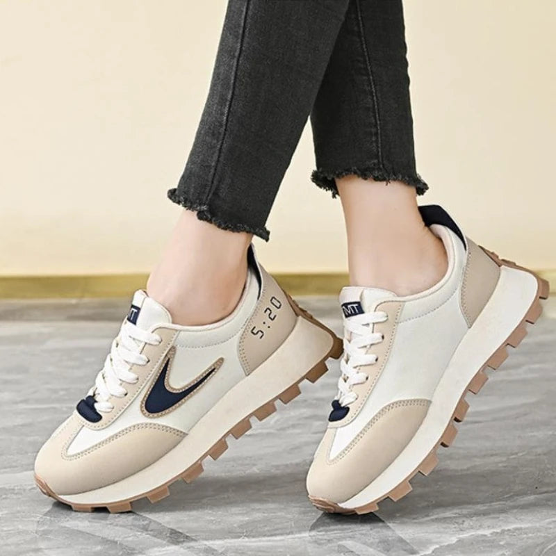  Women Breathable Casual Sneakers worn with a black hoodie, showcasing light comfort shoes in a stylish setting.
