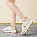  Women Breathable Casual Sneakers worn with a black hoodie, showcasing light comfort shoes in a stylish setting.