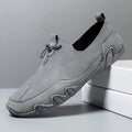 Men’s Casual Leather Sneakers – Comfortable Walking Shoes in a hand-held view showcasing black leather design