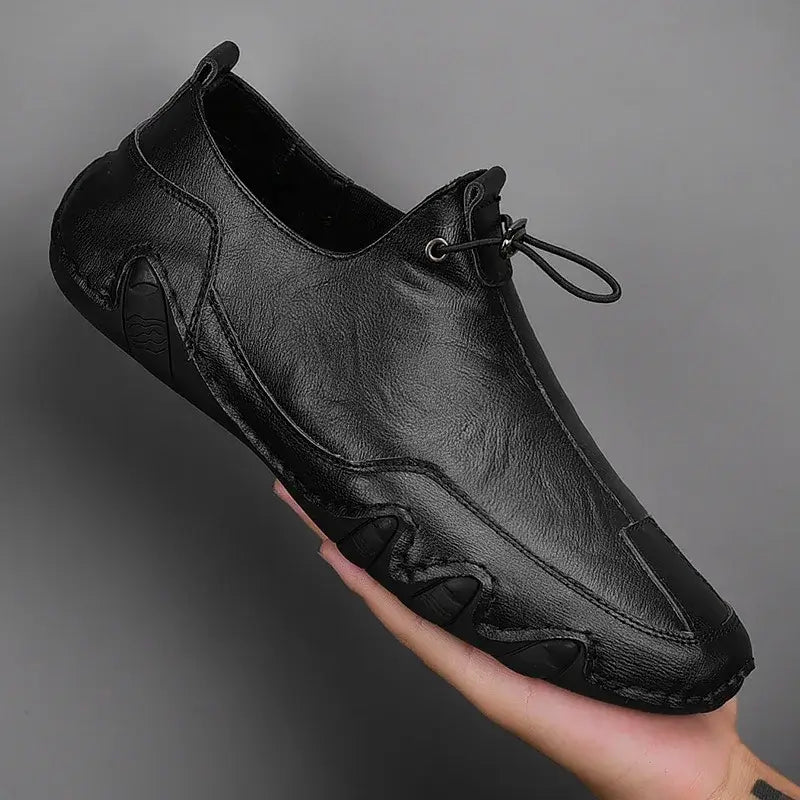 Men’s Casual Leather Sneakers – Comfortable Walking Shoes in a hand-held view showcasing black leather design