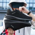 Men's Lightweight Running Sneakers in black being laced up, perfect for casual and sporty looks.