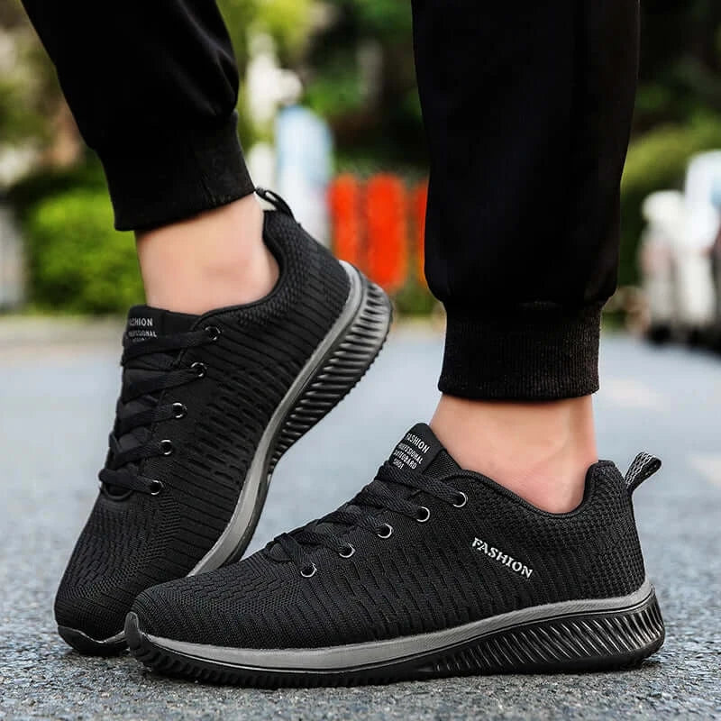 Men's Lightweight Running Sneakers in black being laced up, perfect for casual and sporty looks.