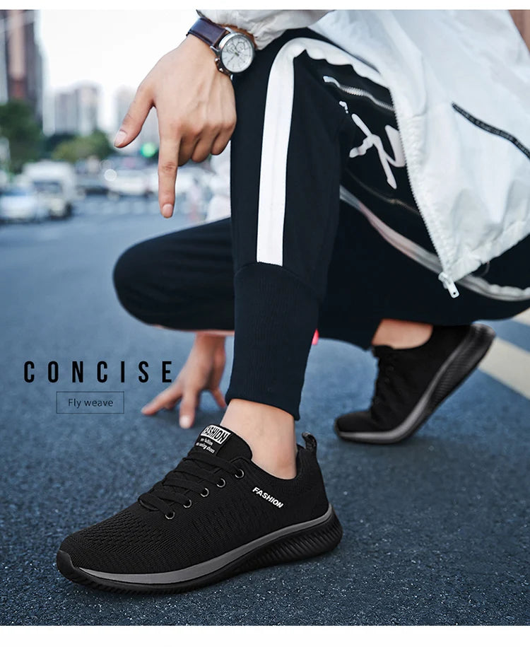 Men's Lightweight Running Sneakers in black being laced up, perfect for casual and sporty looks.