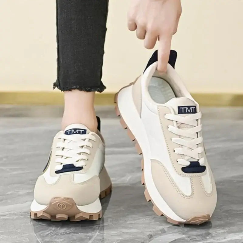  Women Breathable Casual Sneakers worn with a black hoodie, showcasing light comfort shoes in a stylish setting.