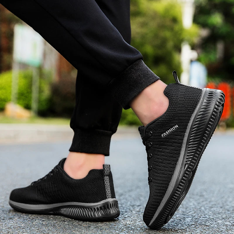 Men's Lightweight Running Sneakers in black being laced up, perfect for casual and sporty looks.