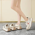  Women Breathable Casual Sneakers worn with a black hoodie, showcasing light comfort shoes in a stylish setting.