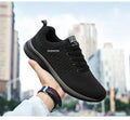 Men's Lightweight Running Sneakers in black being laced up, perfect for casual and sporty looks.