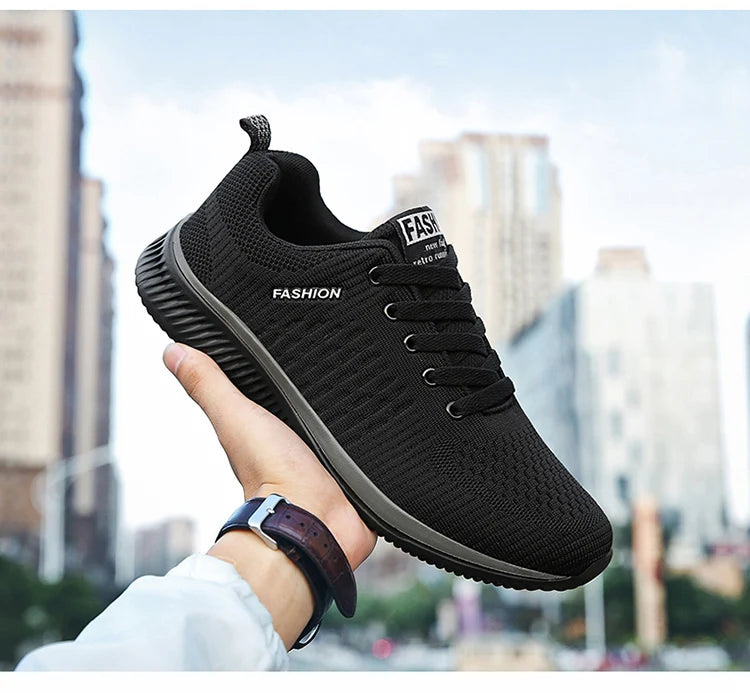 Men's Lightweight Running Sneakers in black being laced up, perfect for casual and sporty looks.